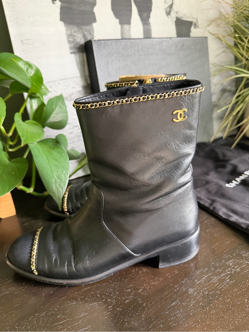 CHANEL Black Leather Mid-Calf Boots with Gold Chain Accent